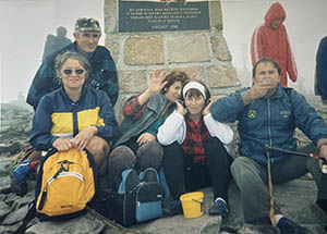 A group of people in outdoor gear, posing for the camera