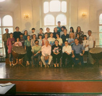 People posed for a group photo, many holding instruments